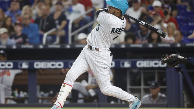 Sep 15, 2023; Miami, Florida, USA; Miami Marlins second baseman Luis Arraez (3) hits a home run against the Atlanta Braves during the first inning at loan Depot Park. Mandatory Credit: Rhona Wise-USA TODAY Sports
