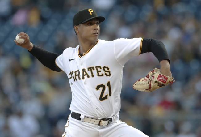 Sep 15, 2023; Pittsburgh, Pennsylvania, USA;  Pittsburgh Pirates starting pitcher Johan Oviedo (24 wearing 21) delivers a pitch against the New York Yankees during the first inning at PNC Park. Mandatory Credit: Charles LeClaire-USA TODAY Sports