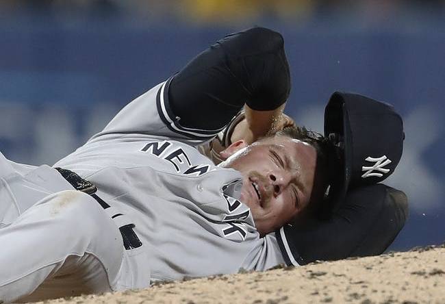 Sep 15, 2023; Pittsburgh, Pennsylvania, USA;  New York Yankees relief pitcher Anthony Misiewicz (54) reacts after being hit in the head by a line drive off the bat of Pittsburgh Pirates second baseman Ji Hwan Bae (not pictured) during the sixth inning at PNC Park. Misiewicz would leave the game.Mandatory Credit: Charles LeClaire-USA TODAY Sports