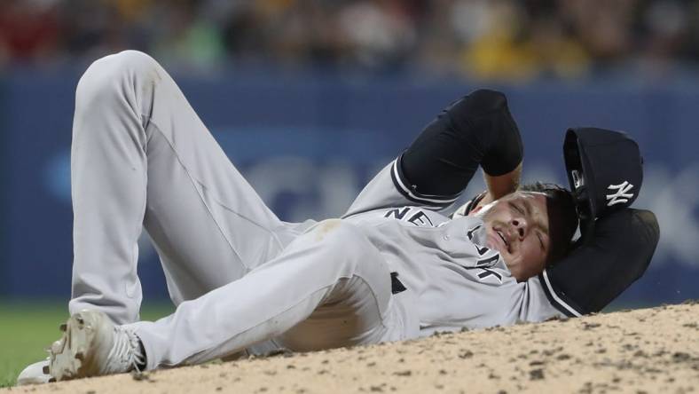 Sep 15, 2023; Pittsburgh, Pennsylvania, USA;  New York Yankees relief pitcher Anthony Misiewicz (54) reacts after being hit in the head by a line drive off the bat of Pittsburgh Pirates second baseman Ji Hwan Bae (not pictured) during the sixth inning at PNC Park. Misiewicz would leave the game.Mandatory Credit: Charles LeClaire-USA TODAY Sports