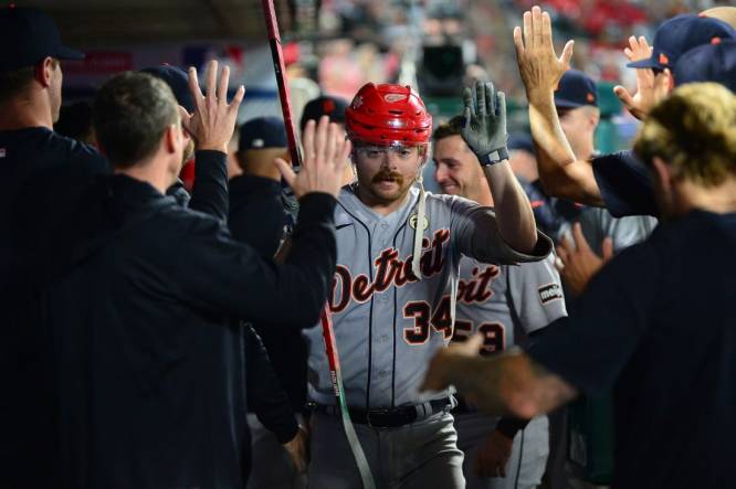Sep 15, 2023; Anaheim, California, USA; Detroit Tigers catcher Jake Rogers (34) is greeted hitting a solo home run against the Los Angeles Angels during the sixth inning at Angel Stadium. Mandatory Credit: Gary A. Vasquez-USA TODAY Sports