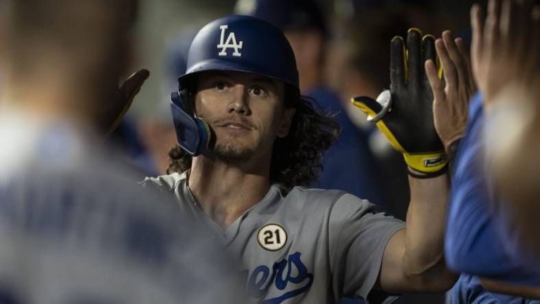 Sep 15, 2023; Seattle, Washington, USA; Los Angeles Dodgers centerfielder James Outman (33) is congratulated by teammates in the dugout after hitting a solo home run during the ninth inning against the Seattle Mariners at T-Mobile Park. Mandatory Credit: Stephen Brashear-USA TODAY Sports