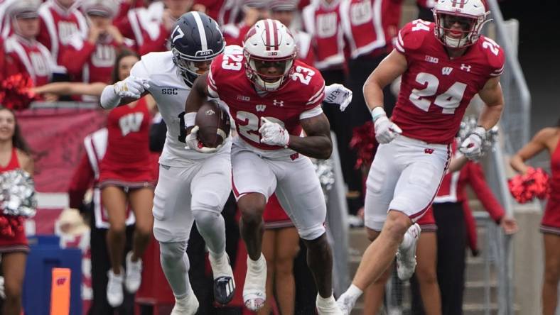 Sep 16, 2023; Madison, Wisconsin, USA; Wisconsin Badgers cornerback Jason Maitre (23) returns an interception against Georgia Southern Eagles during the second quarter at Camp Randall Stadium. Mandatory Credit: Mark Hoffman-USA TODAY Sports