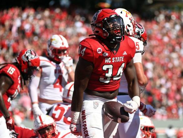 Sep 16, 2023; Raleigh, North Carolina, USA; North Carolina State Wolfpack running back Delbert Mimms III (34) celebrates a touchdown during the first half against the Virginia Military Institute Keydets at Carter-Finley Stadium. Mandatory Credit: Rob Kinnan-USA TODAY Sports