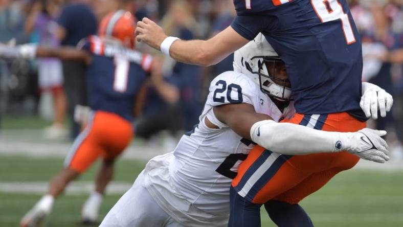 Sep 16, 2023; Champaign, Illinois, USA;  Penn State Nittany Lions defensive end Adisa Isaac (20) tackles Illinois Fighting Illini quarterback Luke Altmyer (9) as he passes the ball during the second half at Memorial Stadium. Mandatory Credit: Ron Johnson-USA TODAY Sports