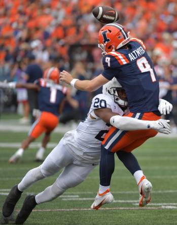 Sep 16, 2023; Champaign, Illinois, USA;  Penn State Nittany Lions defensive end Adisa Isaac (20) tackles Illinois Fighting Illini quarterback Luke Altmyer (9) as he passes the ball during the second half at Memorial Stadium. Mandatory Credit: Ron Johnson-USA TODAY Sports