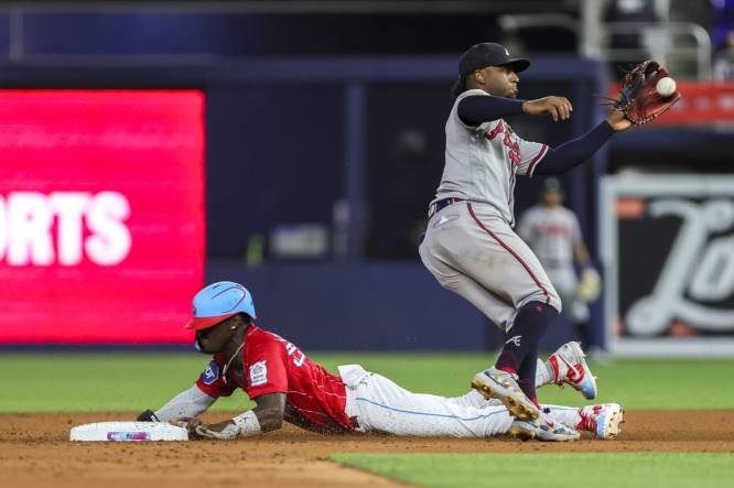 Sep 16, 2023; Miami, Florida, USA; Miami Marlins center fielder Jazz Chisholm Jr. (2) steals second base against Atlanta Braves second baseman Ozzie Albies (1) during the fifth inning at loanDepot Park. Mandatory Credit: Sam Navarro-USA TODAY Sports