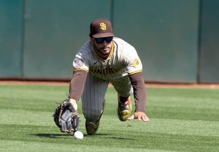 Sep 16, 2023; Oakland, California, USA; San Diego Padres center fielder Trent Grisham (1) misses a catch hit by Oakland Athletics center fielder Lawrence Butler during the fourth inning at Oakland-Alameda County Coliseum. Mandatory Credit: D. Ross Cameron-USA TODAY Sports