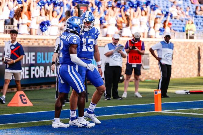 Sep 16, 2023; Durham, North Carolina, USA; Duke Blue Devils quarterback Riley Leonard (13) scores a touchdown and celebrates with wide receiver Sahmir Hagans (2) during the second half against Northwestern Wildcats at Wallace Wade Stadium. Mandatory Credit: Jaylynn Nash-USA TODAY Sports