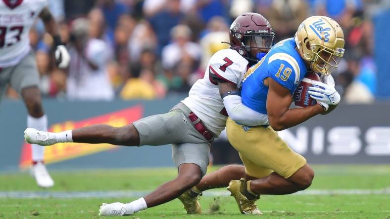 Sep 16, 2023; Pasadena, California, USA; UCLA Bruins wide receiver Kyle Ford (19) is brought down by North Carolina Central Eagles defensive back JaJuan Hudson (7) during the first half at Rose Bowl. Mandatory Credit: Gary A. Vasquez-USA TODAY Sports