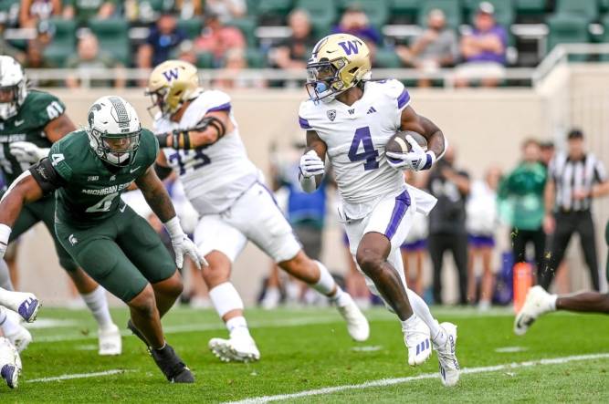 Washington's Germie Bernard, right, runs for a touchdown against Michigan State during the first quarter on Saturday, Sept. 16, 2023, at Spartan Stadium in East Lansing.