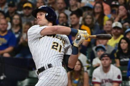 Sep 16, 2023; Milwaukee, Wisconsin, USA; Milwaukee Brewers left fielder Mark Canha (21) drives in a run with a base hit against the Washington Nationals in the first inning at American Family Field. Mandatory Credit: Benny Sieu-USA TODAY Sports