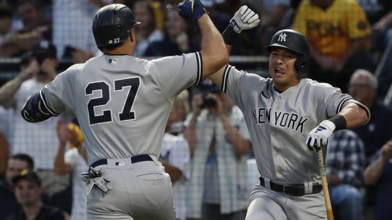 Sep 16, 2023; Pittsburgh, Pennsylvania, USA; New York Yankees shortstop Anthony Volpe (right) congratulates designated hitter Giancarlo Stanton (27) on his solo home run against the Pittsburgh Pirates during the third inning at PNC Park. Mandatory Credit: Charles LeClaire-USA TODAY Sports