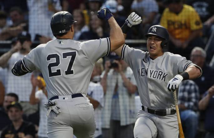Sep 16, 2023; Pittsburgh, Pennsylvania, USA; New York Yankees shortstop Anthony Volpe (right) congratulates designated hitter Giancarlo Stanton (27) on his solo home run against the Pittsburgh Pirates during the third inning at PNC Park. Mandatory Credit: Charles LeClaire-USA TODAY Sports