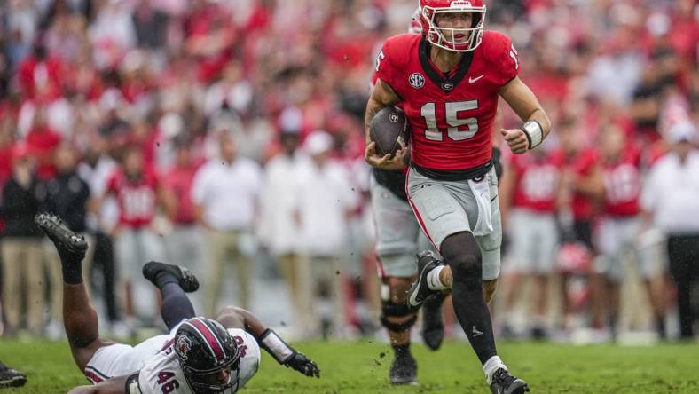 Sep 16, 2023; Athens, Georgia, USA; Georgia Bulldogs quarterback Carson Beck (15) runs past South Carolina Gamecocks defensive end Bryan Thomas Jr. (46) during the first half at Sanford Stadium. Mandatory Credit: Dale Zanine-USA TODAY Sports