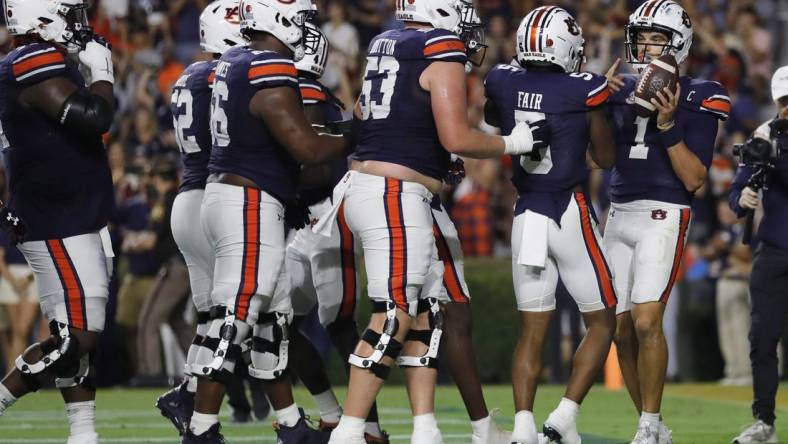 Sep 16, 2023; Auburn, Alabama, USA; Auburn Tigers quarterback Payton Thorne (1) celebrates with teammates after scoring a touchdown against the Samford Bulldogs during the second quarter at Jordan-Hare Stadium. Mandatory Credit: John Reed-USA TODAY Sports