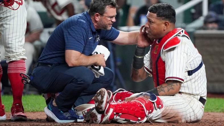 Sep 16, 2023; Kansas City, Missouri, USA; A staff member works with Kansas City Royals catcher Salvador Perez (13) against the Houston Astros after an injury in the fifth inning at Kauffman Stadium. Mandatory Credit: Denny Medley-USA TODAY Sports