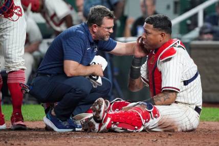 Sep 16, 2023; Kansas City, Missouri, USA; A staff member works with Kansas City Royals catcher Salvador Perez (13) against the Houston Astros after an injury in the fifth inning at Kauffman Stadium. Mandatory Credit: Denny Medley-USA TODAY Sports