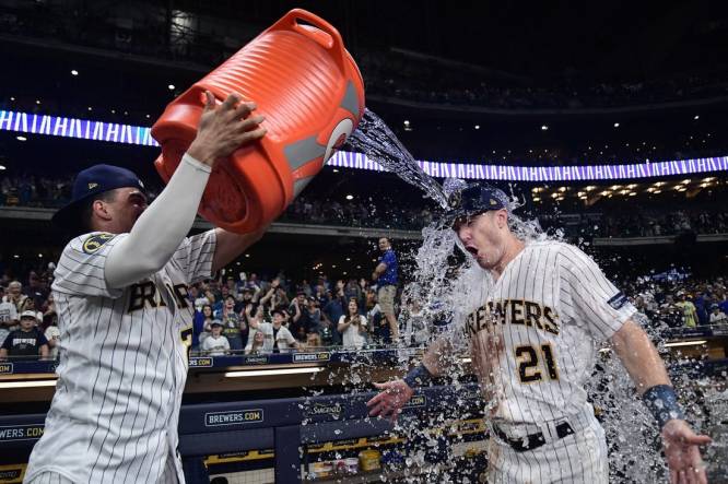 Sep 16, 2023; Milwaukee, Wisconsin, USA;  Milwaukee Brewers left fielder Mark Canha (21) gets dunked by shortstop Willy Adames (27) after beating the Washington Nationals at American Family Field. Mandatory Credit: Benny Sieu-USA TODAY Sports
