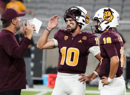 Arizona State Sun Devils offensive coordinator Beau Baldwin talks to his quarterbacks Drew Pyne (10) and Trenton Bourguet (16) during pregame warms-up before playing the Fresno State Bulldogs at Mountain America Stadium in Tempe on Sept. 16, 2023.