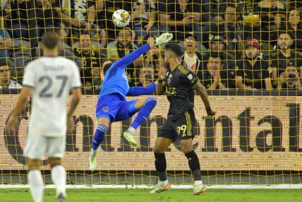 Sep 16, 2023; Los Angeles, California, USA;  Los Angeles FC forward Denis Bouanga (99) scores a goal past Los Angeles Galaxy goalkeeper Jonathan Bond (1) off a pass by Los Angeles Galaxy forward Michael Barrios (12) in the first half at BMO Stadium. Mandatory Credit: Jayne Kamin-Oncea-USA TODAY Sports