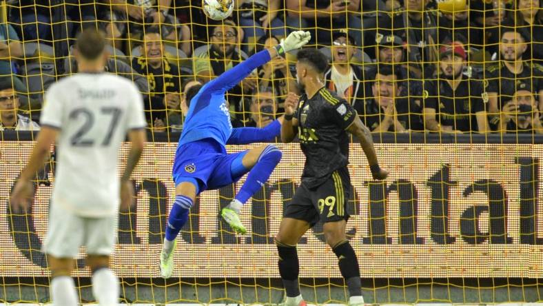 Sep 16, 2023; Los Angeles, California, USA;  Los Angeles FC forward Denis Bouanga (99) scores a goal past Los Angeles Galaxy goalkeeper Jonathan Bond (1) off a pass by Los Angeles Galaxy forward Michael Barrios (12) in the first half at BMO Stadium. Mandatory Credit: Jayne Kamin-Oncea-USA TODAY Sports