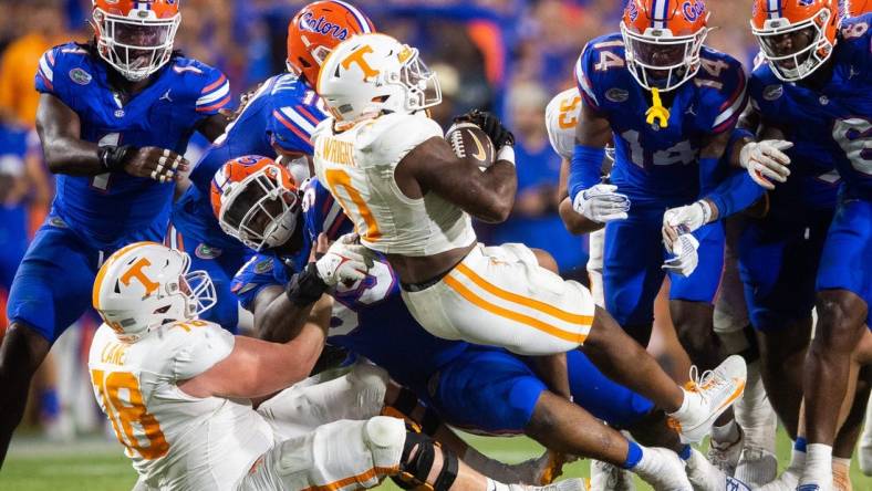 Tennessee running back Jaylen Wright (0) is swarmed by Florida defenders during a football game between Tennessee and Florida at Ben Hill Griffin Stadium in Gainesville, Fla., on Saturday, Sept. 16, 2023.