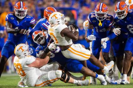 Tennessee running back Jaylen Wright (0) is swarmed by Florida defenders during a football game between Tennessee and Florida at Ben Hill Griffin Stadium in Gainesville, Fla., on Saturday, Sept. 16, 2023.