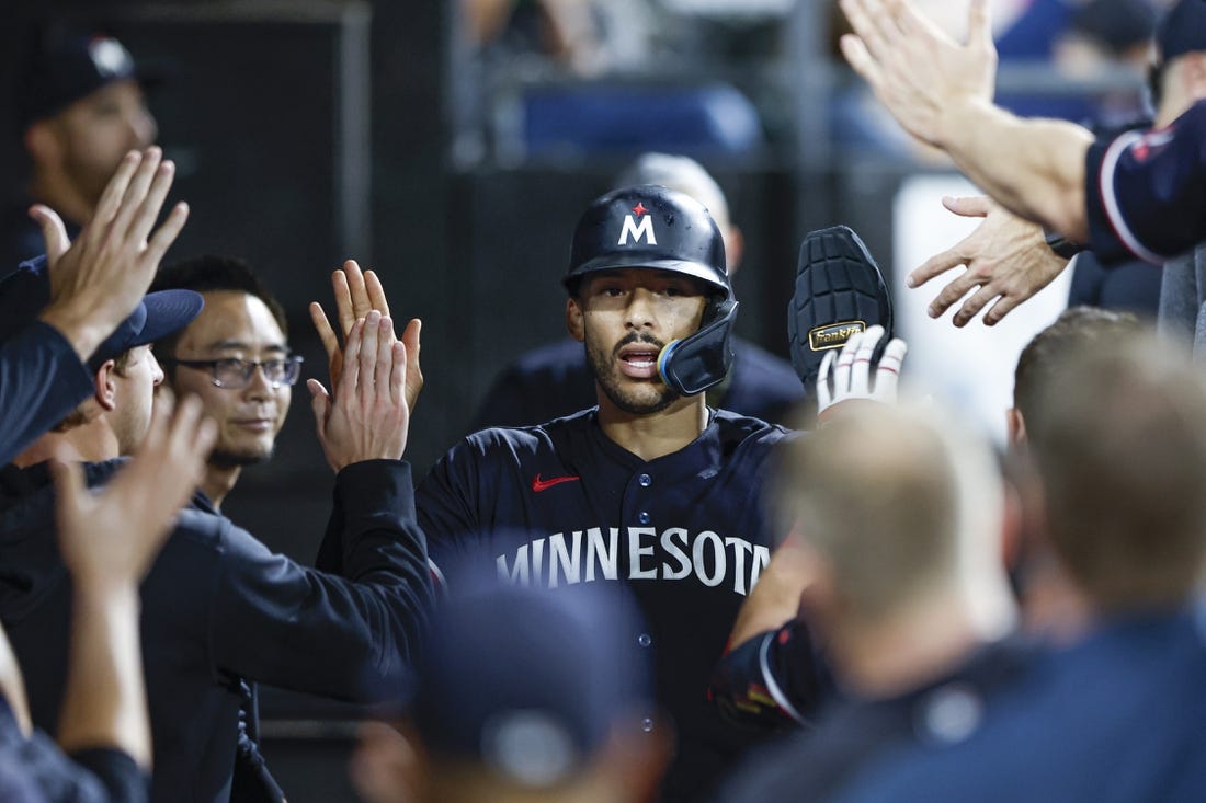 Sep 16, 2023; Chicago, Illinois, USA; Minnesota Twins shortstop Carlos Correa (4) celebrates with teammates after scoring against the Chicago White Sox during the eight inning at Guaranteed Rate Field. Mandatory Credit: Kamil Krzaczynski-USA TODAY Sports