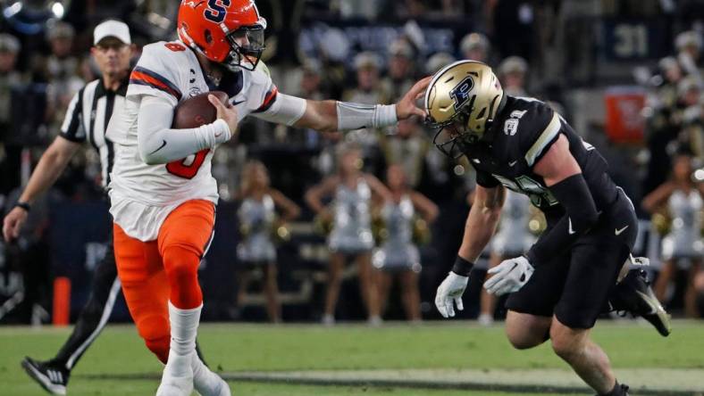 Syracuse Orange quarterback Garrett Shrader (6) stiff arms Purdue Boilermakers defensive back Dillon Thieneman (31) during the NCAA football game, Saturday, Sept. 16, 2023, at Ross-Ade Stadium in West Lafayette, Ind. Syracuse Orange won 35-20.