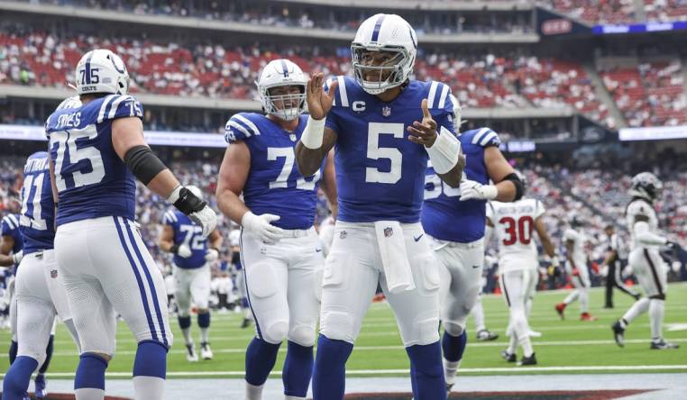 Sep 17, 2023; Houston, Texas, USA; Indianapolis Colts quarterback Anthony Richardson (5) celebrates after scoring a touchdown during the first quarter against the Houston Texans at NRG Stadium. Mandatory Credit: Troy Taormina-USA TODAY Sports