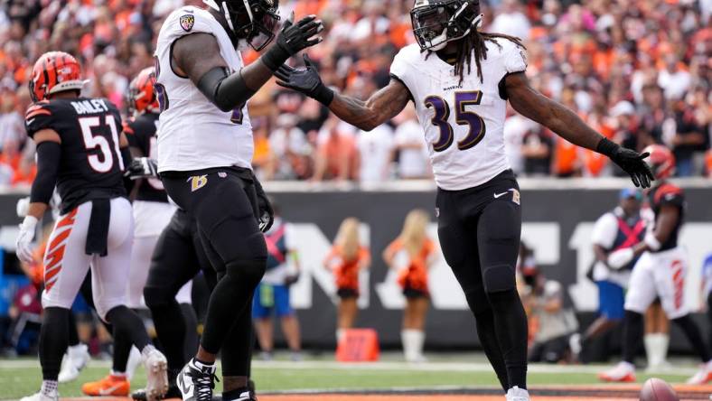 Sep 17, 2023; Cincinnati, Ohio, USA; Baltimore Ravens running back Gus Edwards (35) celebrates a touchdown with Baltimore Ravens offensive tackle Morgan Moses (78) in the first quarter at Paycor Stadium. Mandatory Credit: Albert Cesare-USA TODAY Sports