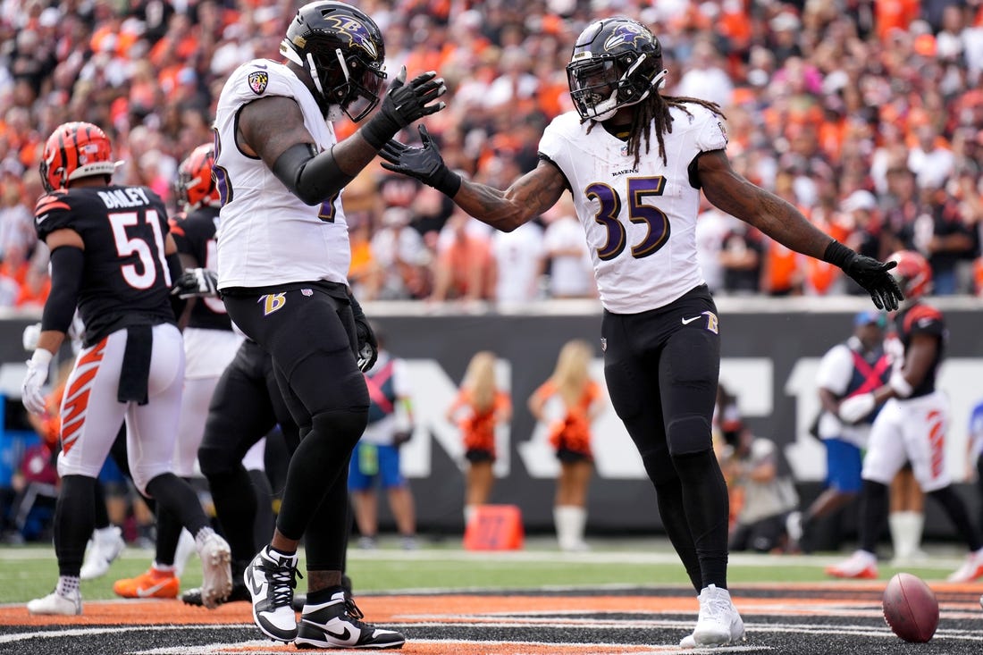 Sep 17, 2023; Cincinnati, Ohio, USA; Baltimore Ravens running back Gus Edwards (35) celebrates a touchdown with Baltimore Ravens offensive tackle Morgan Moses (78) in the first quarter at Paycor Stadium. Mandatory Credit: Albert Cesare-USA TODAY Sports
