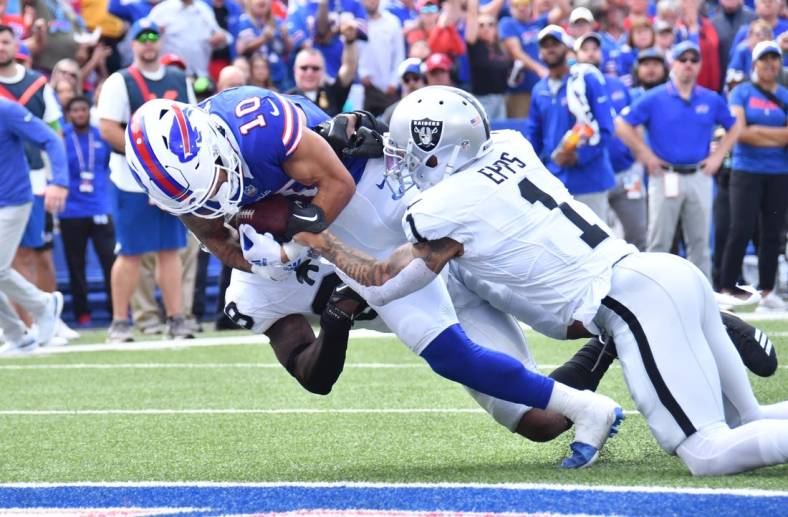 Sep 17, 2023; Orchard Park, New York, USA; Buffalo Bills wide receiver Khalil Shakir (10) scores a touchdown as he is tackled by Las Vegas Raiders safety Marcus Epps (1) in the second quarter at Highmark Stadium. Mandatory Credit: Mark Konezny-USA TODAY Sports