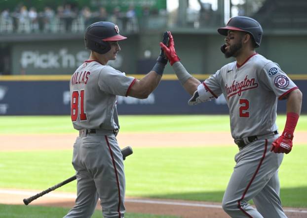 Sep 17, 2023; Milwaukee, Wisconsin, USA;Washington Nationals catcher Drew Millas (81), left congratulates Washington Nationals second baseman Luis Garcia (2) after hitting a home run against the Milwaukee Brewers in the first inning at American Family Field. Mandatory Credit: Michael McLoone-USA TODAY Sports