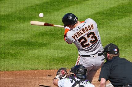 Sep 17, 2023; Denver, Colorado, USA;  San Francisco Giants designated hitter Joc Pederson (23) hits a RBI double in the sixth inning against the Colorado Rockies at Coors Field. Mandatory Credit: Ron Chenoy-USA TODAY Sports