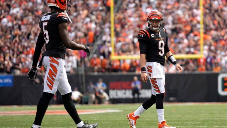 Cincinnati Bengals quarterback Joe Burrow (9) looks toward Cincinnati Bengals wide receiver Tee Higgins (5) while coming off the field in the second quarter of a Week 2 NFL football game between the Baltimore Ravens and the Cincinnati Bengals Sunday, Sept. 17, 2023, at Paycor Stadium in Cincinnati.