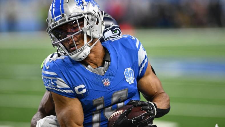 Sep 17, 2023; Detroit, Michigan, USA; Detroit Lions wide receiver Amon-Ra St. Brown (14) catches a pass against the Seattle Seahawks in the second quarter at Ford Field. Mandatory Credit: Lon Horwedel-USA TODAY Sports