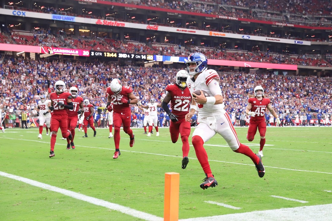 Sep 17, 2023; Glendale, Arizona, USA; New York Giants quarterback Daniel Jones (8) runs for a touchdown against the Arizona Cardinals during the second half at State Farm Stadium. Mandatory Credit: Joe Camporeale-USA TODAY Sports