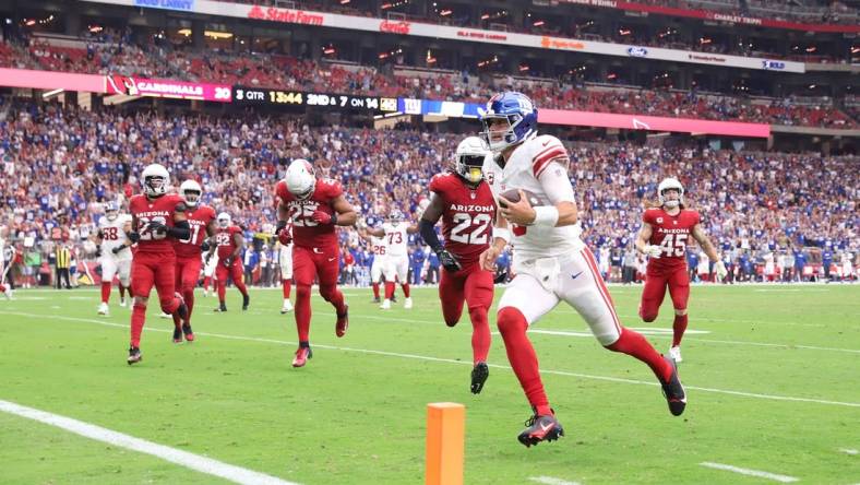 Sep 17, 2023; Glendale, Arizona, USA; New York Giants quarterback Daniel Jones (8) runs for a touchdown against the Arizona Cardinals during the second half at State Farm Stadium. Mandatory Credit: Joe Camporeale-USA TODAY Sports