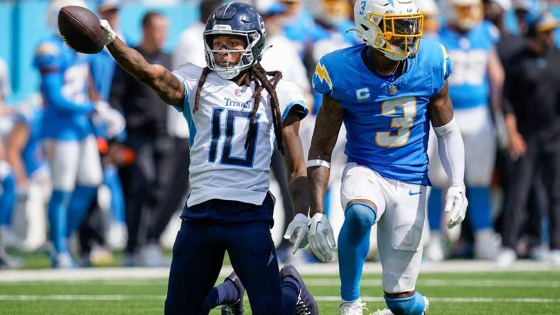 Tennessee Titans wide receiver DeAndre Hopkins (10) celebrates receiving a pass next to Los Angeles Chargers safety Derwin James Jr. (3) during the fourth quarter at Nissan Stadium in Nashville, Tenn., Sunday, Sept. 17, 2023.