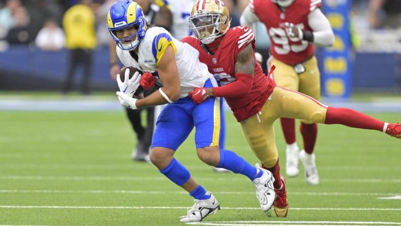 Sep 17, 2023; Inglewood, California, USA; Los Angeles Rams wide receiver Puka Nacua (17) is stopped by San Francisco 49ers cornerback Deommodore Lenoir (2) after a 32 yard pass play in the second half at SoFi Stadium. Mandatory Credit: Jayne Kamin-Oncea-USA TODAY Sports