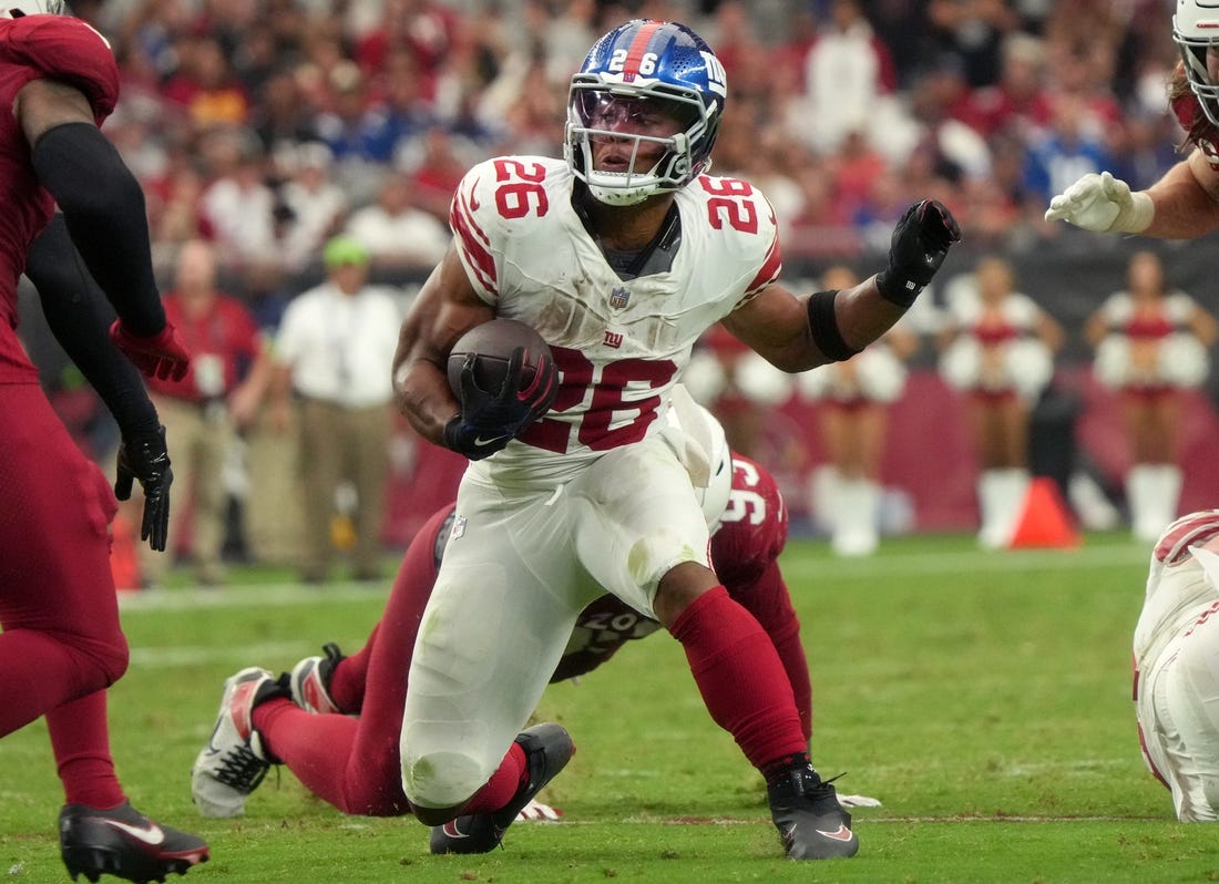 New York Giants running back Saquon Barkley (26) runs the ball against the Arizona Cardinals at State Farm Stadium in Glendale on Sept. 17, 2023.