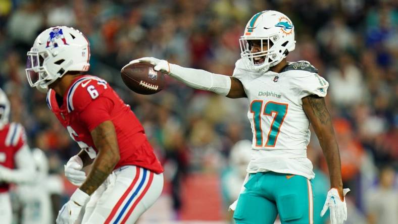 Sep 17, 2023; Foxborough, Massachusetts, USA; Miami Dolphins wide receiver Jaylen Waddle (17) reacts after his first down catch against New England Patriots cornerback Christian Gonzalez (6) in the second quarter at Gillette Stadium. Mandatory Credit: David Butler II-USA TODAY Sports