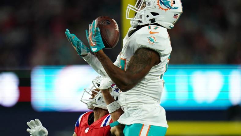 Sep 17, 2023; Foxborough, Massachusetts, USA; Miami Dolphins wide receiver Jaylen Waddle (17) makes the catch against New England Patriots cornerback Myles Bryant (27) in the second half at Gillette Stadium. Mandatory Credit: David Butler II-USA TODAY Sports