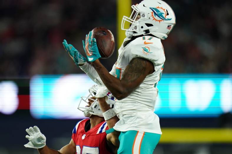 Sep 17, 2023; Foxborough, Massachusetts, USA; Miami Dolphins wide receiver Jaylen Waddle (17) makes the catch against New England Patriots cornerback Myles Bryant (27) in the second half at Gillette Stadium. Mandatory Credit: David Butler II-USA TODAY Sports