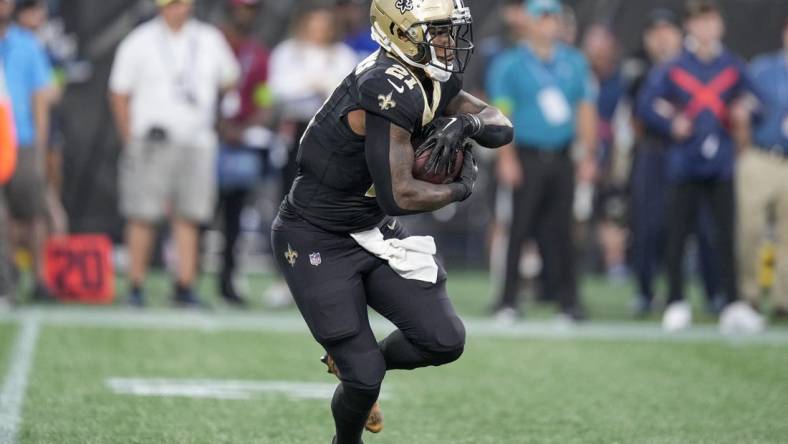 Sep 18, 2023; Charlotte, North Carolina, USA; New Orleans Saints running back Jamaal Williams (21) runs against the New Orleans Saints during the first quarter at Bank of America Stadium. Mandatory Credit: Jim Dedmon-USA TODAY Sports