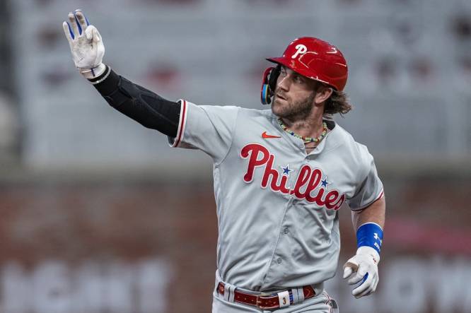 Sep 18, 2023; Cumberland, Georgia, USA; Philadelphia Phillies first baseman Bryce Harper (3) reacts as he runs the bases after hitting a home run against the Atlanta Braves during the third inning at Truist Park. Mandatory Credit: Dale Zanine-USA TODAY Sports