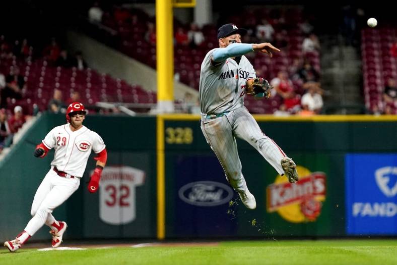 Minnesota Twins third baseman Royce Lewis (23) throws to first base for an out in the seventh inning of a baseball game against the Cincinnati Reds, Monday, Sept. 18, 2023, at Great American Ball Park in Cincinnati.