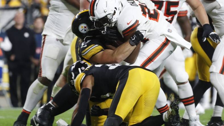 Sep 18, 2023; Pittsburgh, Pennsylvania, USA;  Cleveland Browns running back Nick Chubb (24) is tackled by Pittsburgh Steelers linebacker Cole Holcomb (55) and safety Minkah Fitzpatrick (39) during the second quarter against at Acrisure Stadium. Chubb was injured on the play and taken from the field on a cart. Mandatory Credit: Charles LeClaire-USA TODAY Sports